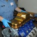 man fitting milodon oil pan on ford modular v8 engine thumbnail