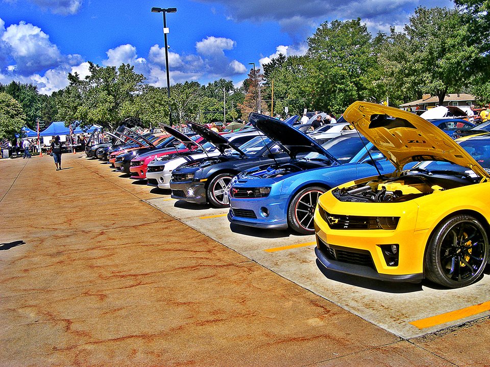 row of fifth gen camaros at a chevy car show