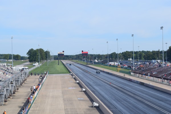 a race car running down the far end of a dragstrip
