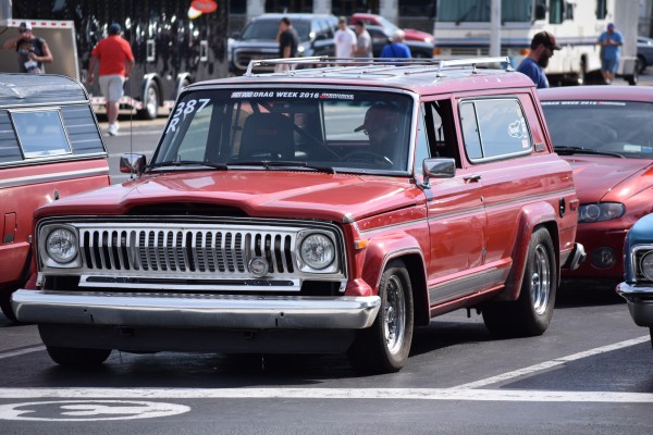 a vintage jeep cherokee suv in staging lanes at drag strip