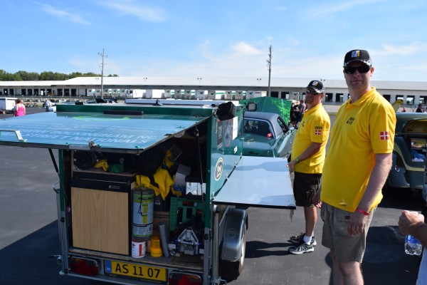 men setting up a small race trailer