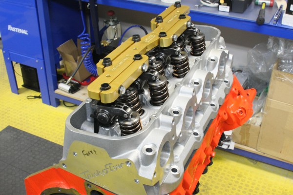 stud girdles on rocker arms in cylinder heads