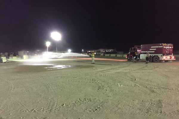 fire department spraying down dirt to stop dust
