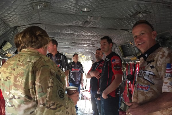 troops and nhra drivers touring cargo helicopter