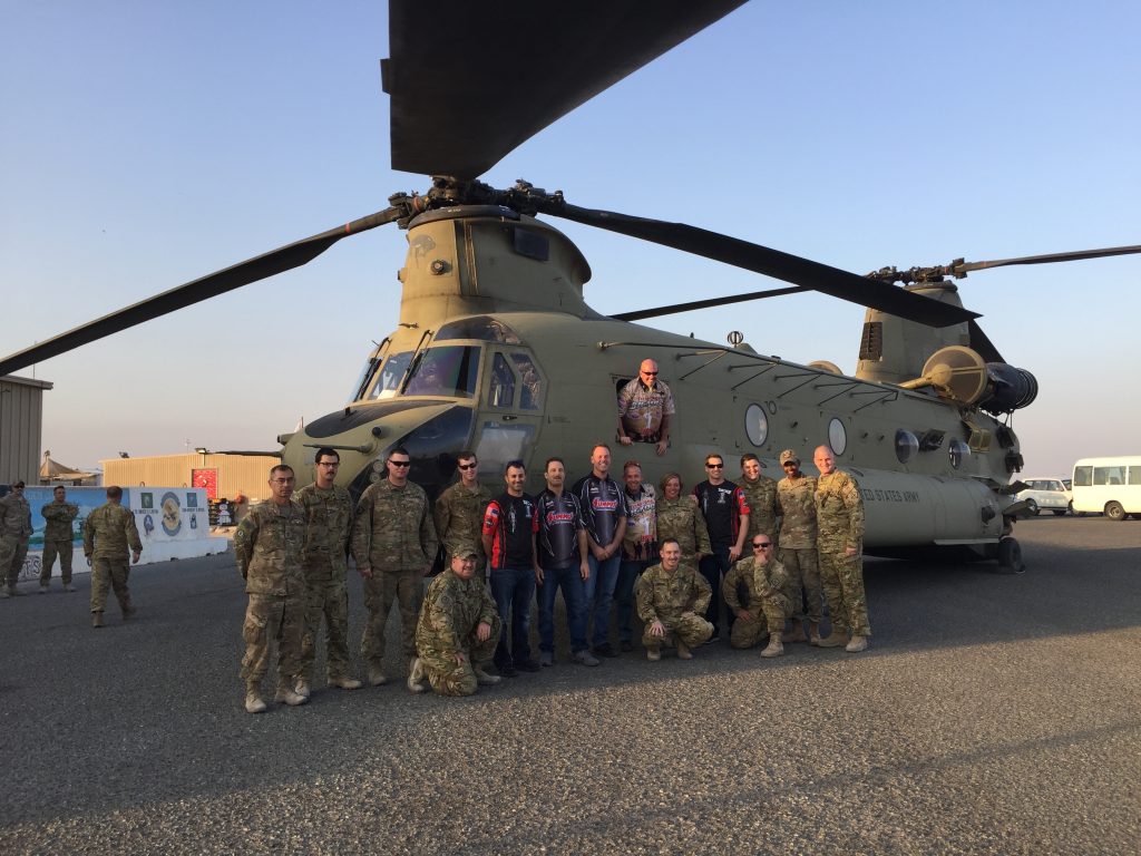 men posing near chinook military helicopter