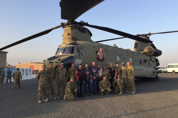 men posing near chinook military helicopter
