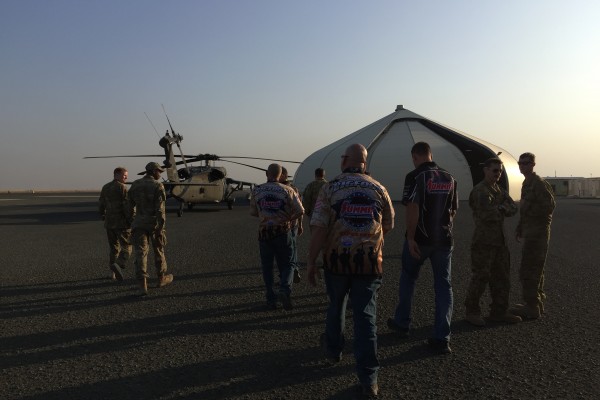 men and women touring a military army air base
