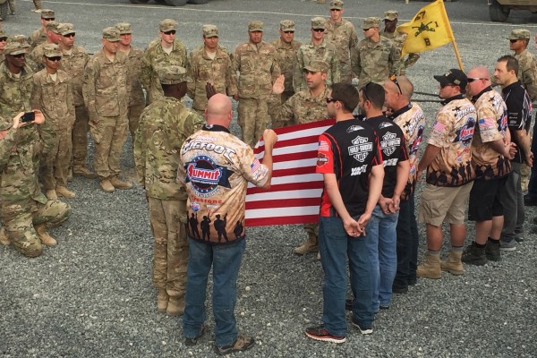 military flag ceremony with race car drivers