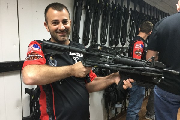 man posing with m4 military weapon