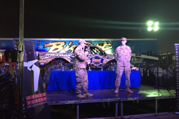 military officers presenting near bigfoot monster truck
