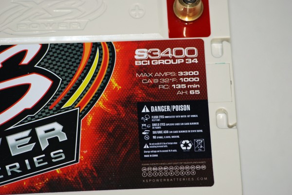 close up of warning label and specs of an xs power battery for a car