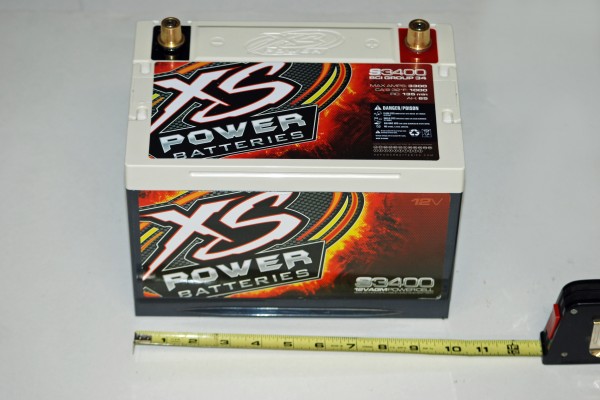 car battery next to tape measure for width