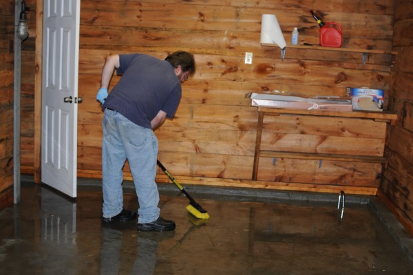 man cleaning garage floor