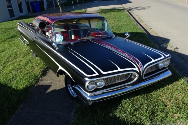 vintage pontiac hot rod coupe with aftermarket air conditioner on window