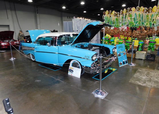 blue 1957 chevy bel air on display at car show