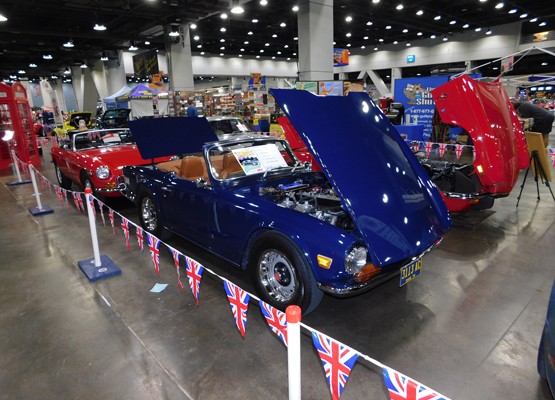 blue triumph roadster at indoor car show