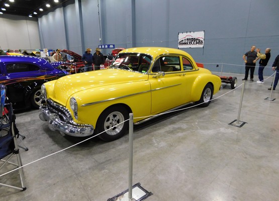 yellow oldmsobile hot rod