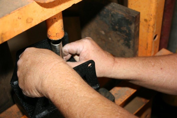pressing wheel studs into spare tire mount