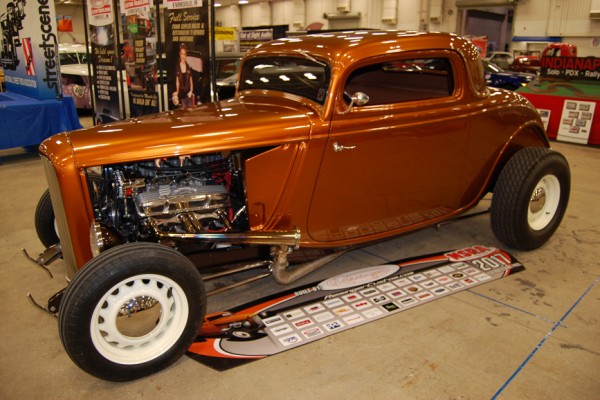 orange metallic hot rod ford coupe with a v8