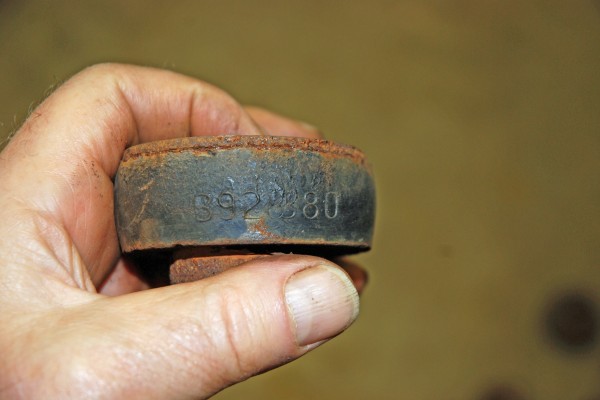 man holding old, worn body bushing