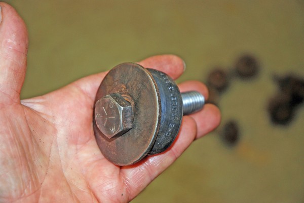 man holding body mount and bushing