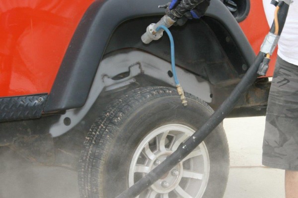 pressure washing wheel well of a jeep wrangler