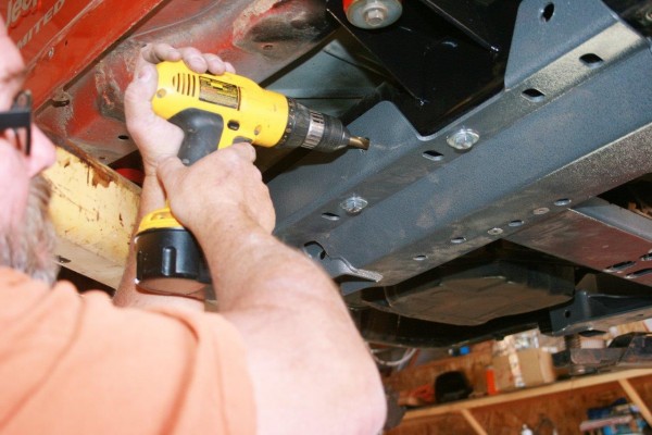 drilling out a hole on a jeep wrangler frame