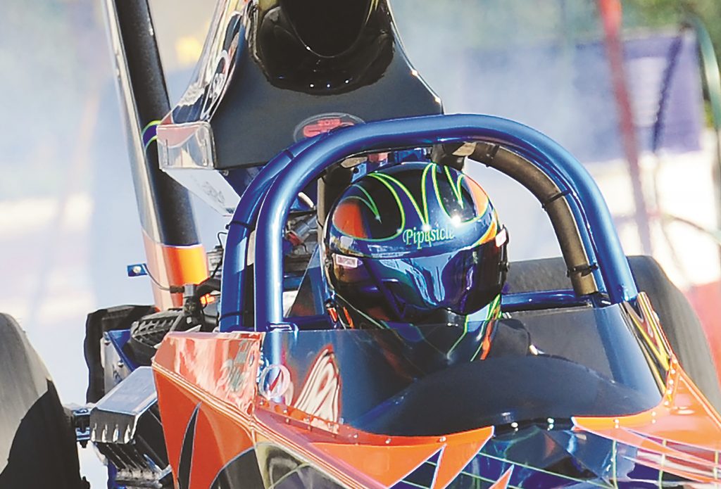 close up of top fuel drag racer helmet during launch