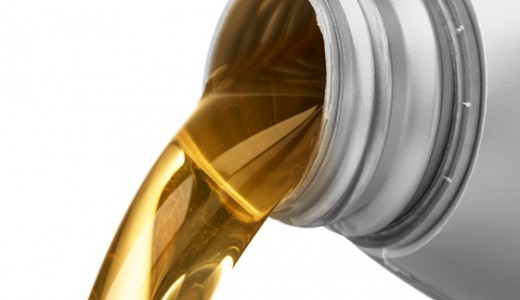 pouring motor oil from a bottle