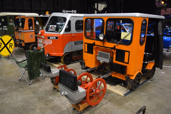 small railroad speeder crew engines on display at a classic car show