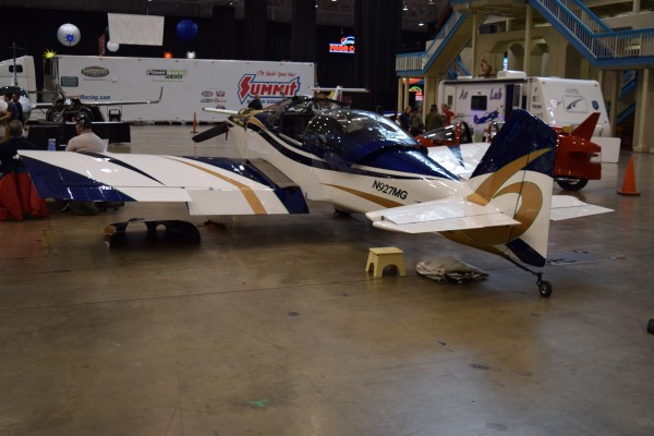 acrobatic single wing monoplane at a car show