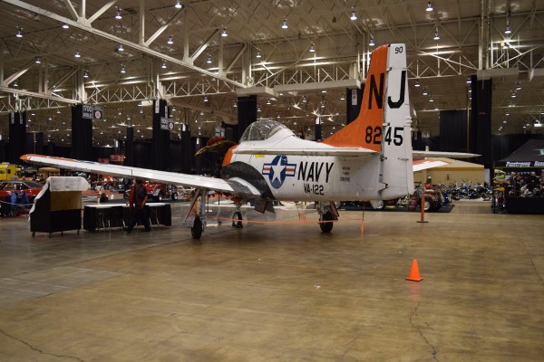 us navy turboprop aircraft on display at a car show