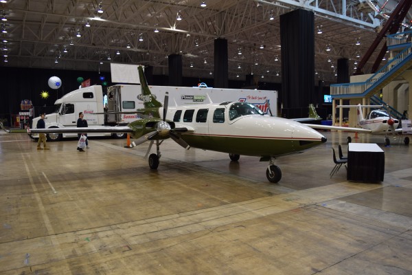twin engine commuter plane at a car show