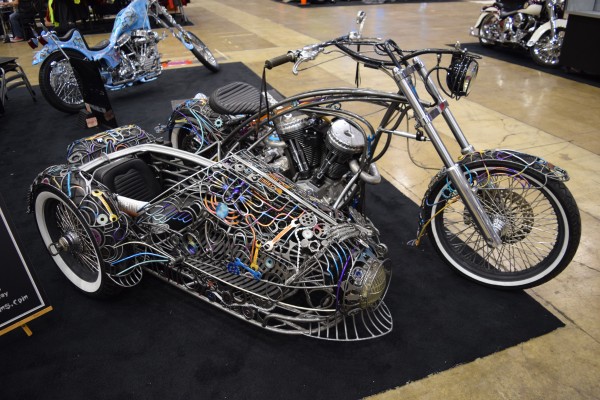 custom panhead v twin motorcycle with wire frame sidecar