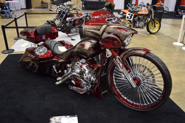 customized bagger v twin motorcycle at a car show