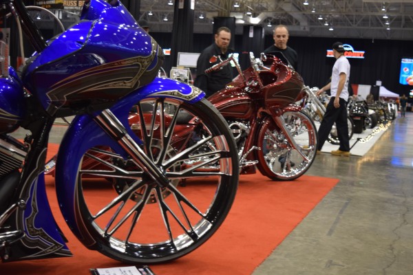 rows of custom motorcycles at a car show