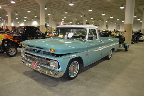vintage chevy c10 pickup truck pulling vintage motorcycle on a trailer