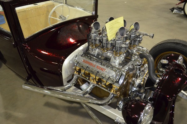 six carburetor intake setup on an oldsmobile rocket v8 engine in a t bucket ford hot rod