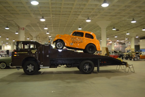 vintage rollback truck with an altered Anglia dragster on back