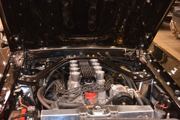 eight separate velocity stacks in a restomodded vintage musclecar engine