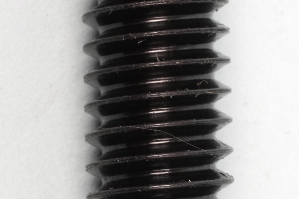 ball bearing placed near the bottom of a bolt thread