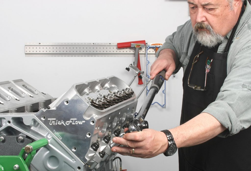 man using torque wrench to install trick flow ls engine cylinder heads