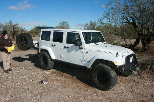 man preparing to wash a jeep wrangler jk rubicon