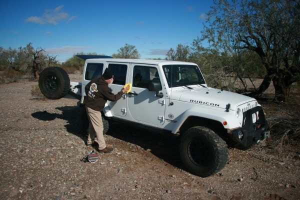 man washing jeep wrangler rubicon
