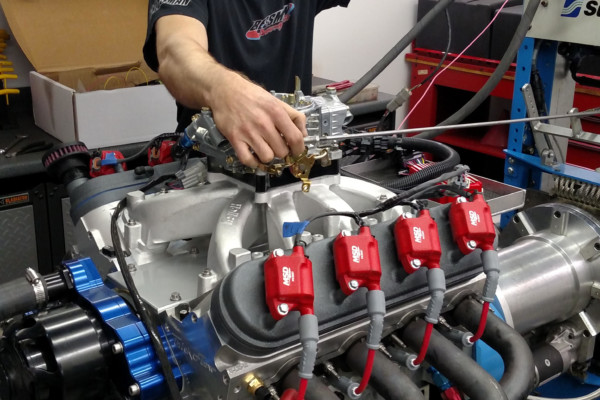 man tuning an ls engine on a dyno