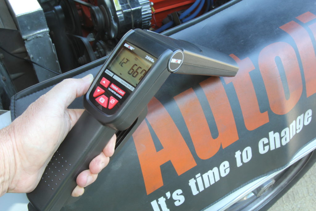 man holding an ignition timing light