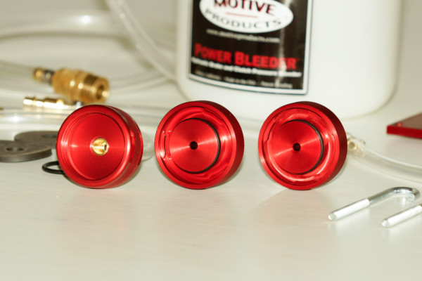 an assortment of pressure caps for a brake bleeding tool