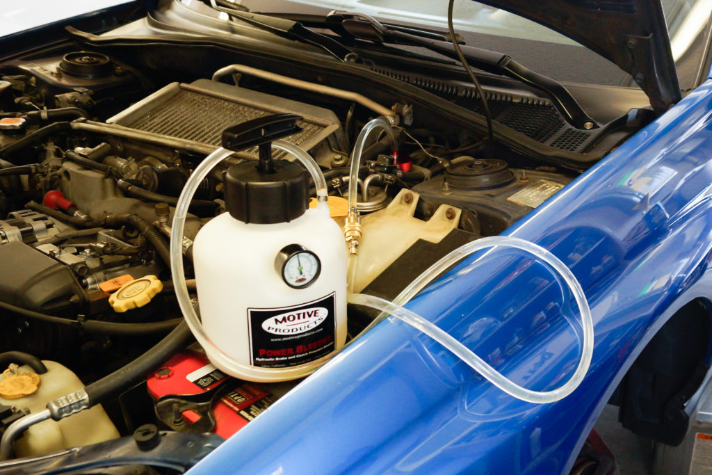 a motive pressurized brake bleeder in use
