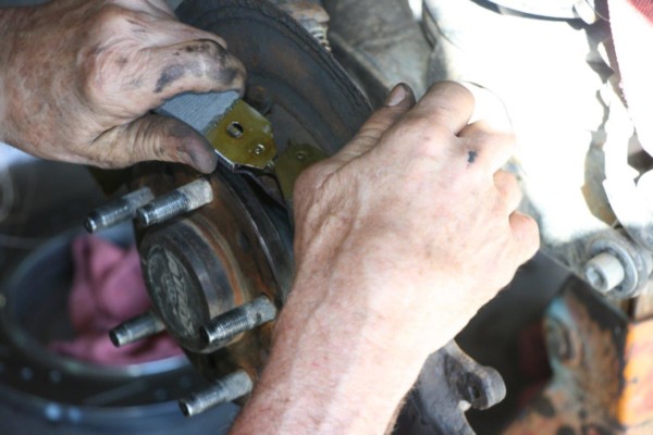 man installing drum brake shoes