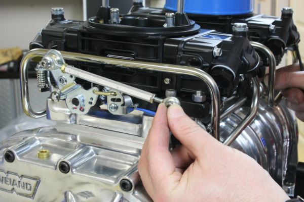 man installing carburetor linkage